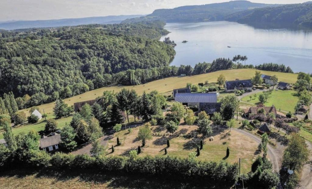 an aerial view of a house on a hill next to a lake at Camping 3 étoiles - ccaidff in Beaulieu