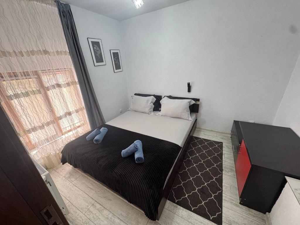 a small bedroom with a bed and a window at Berta Gardens 2 in Sandanski