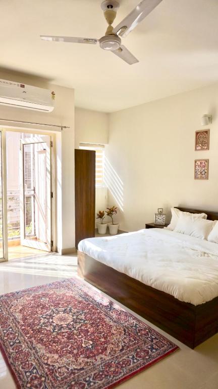 a bedroom with a large bed and a rug at Indran in Chhatikara