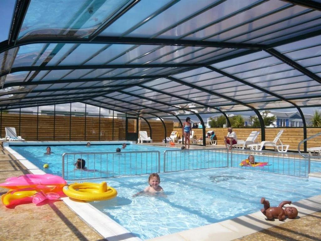 a woman is in a swimming pool with at ZEcamping 3 étoiles piscine chauffée club enfant dog friendly in Ploemeur
