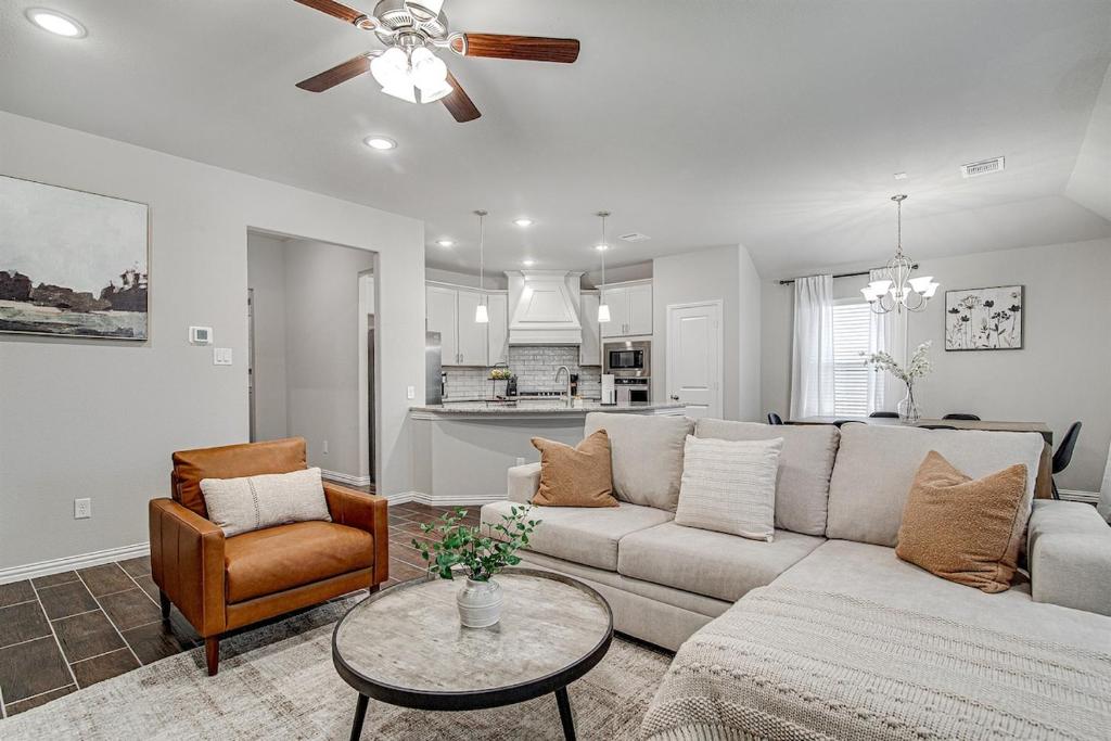 a living room with a couch and a table at Where Comfort Meets Convenience in Burleson