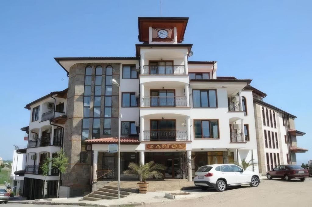 a building with a clock tower on top of it at Apart-Hotel Argo in Lozenets
