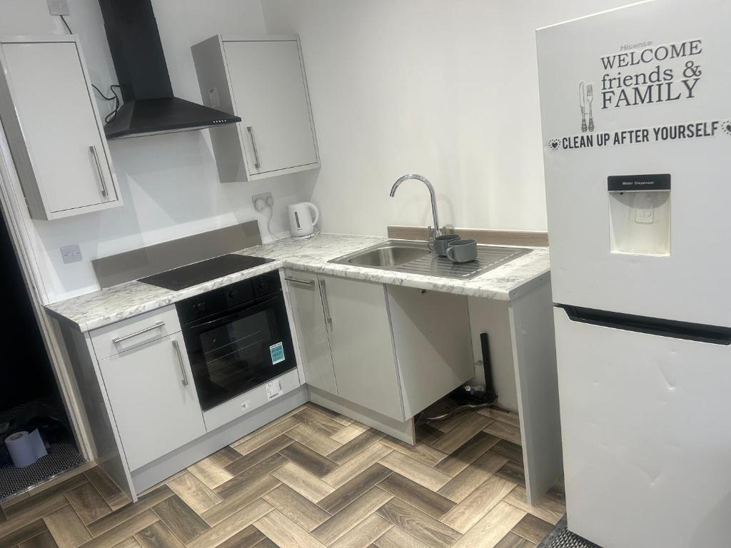 a small kitchen with a sink and a refrigerator at The millstone residents in Bradford