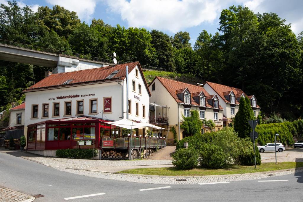 a building on the side of a road with a street at ApartOne Hotel Brückenschänke in Sebnitz