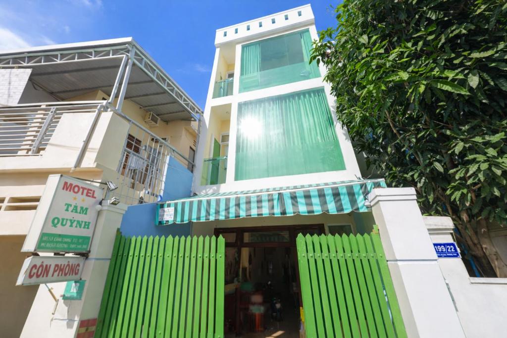 a building with green shutters on it at Tâm Quỳnh Motel in Vung Tau
