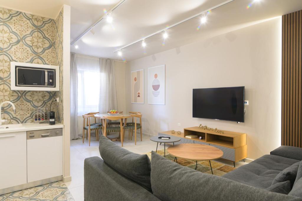 a living room with a couch and a table at Estia Luxury Apartment in Ierapetra