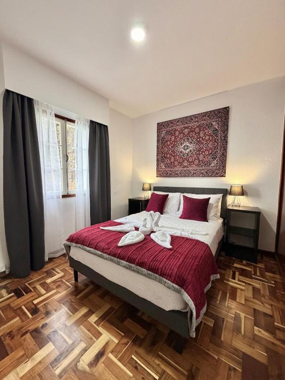 a bedroom with a bed with two towels on it at Ocean View Guest House in São Vicente