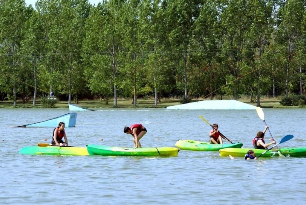 a group of people in kayaks on a lake at ZEcamping 3 étoiles animaux acceptés espace aquatique in Moncontour-de-Poitou