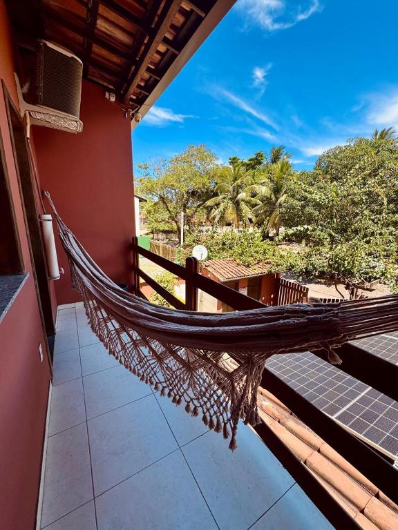 a hammock on the balcony of a house at Flats Coco Coral in Barra Grande