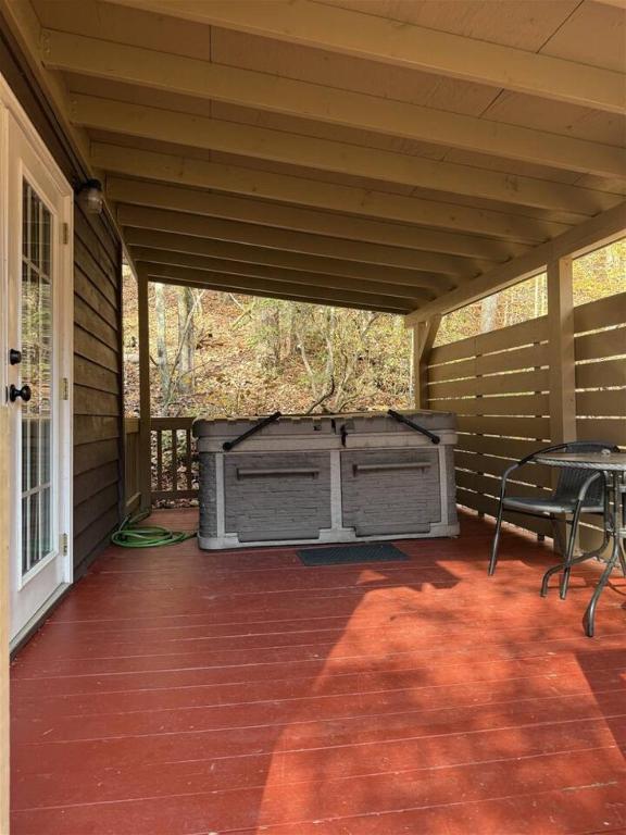 a screened in porch with a grill and a table at Bavarian Hideaway 46 in Sautee Nacoochee