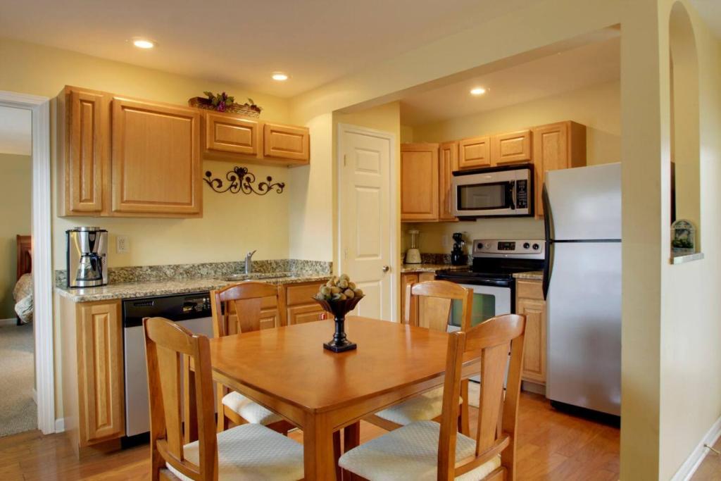 a kitchen with a wooden table and a refrigerator at Bavarian Brook Condo 15 in Helen