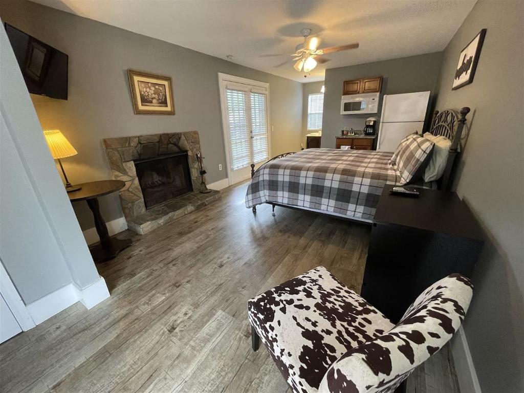 a living room with a bed and a fireplace at Bavarian Brook Unit 9 in Helen