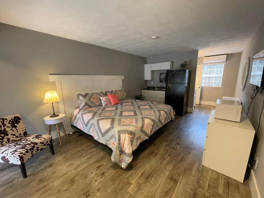 a bedroom with a large bed and a kitchen at Bavarian Brook Unit 8 in Helen