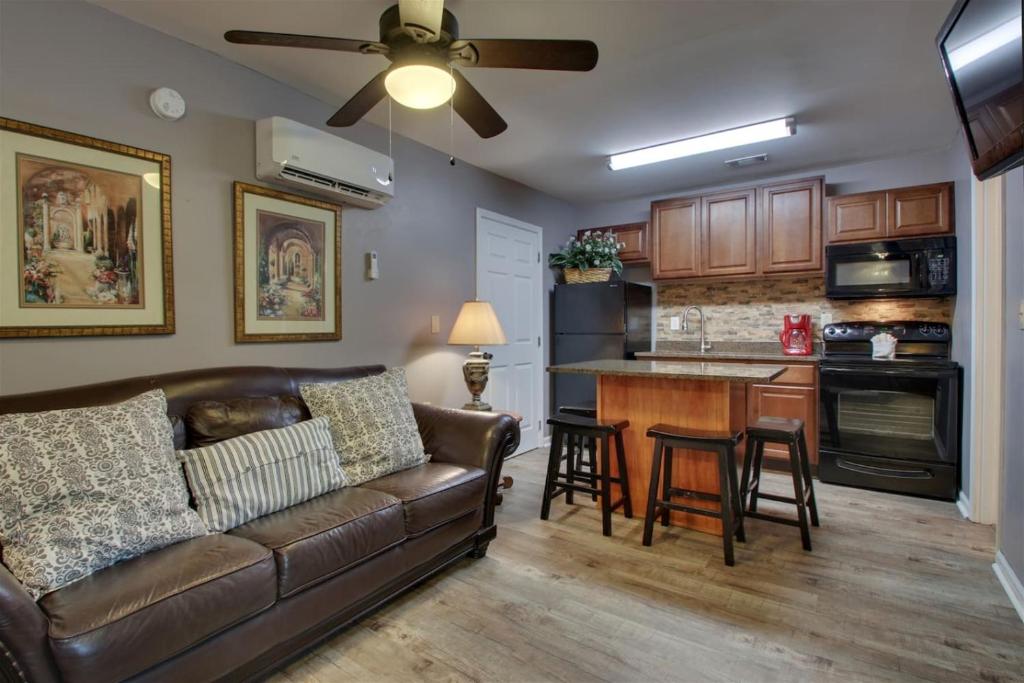 a living room with a couch and a kitchen at Rivers Edge 703 in Helen