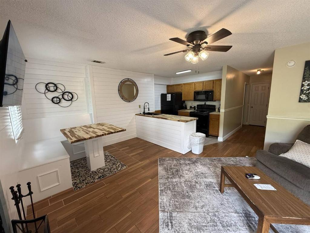 a living room with a couch and a kitchen at Rivers Edge 802 in Helen