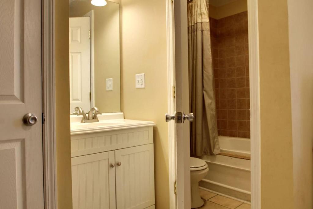a bathroom with a sink and a toilet and a shower at Bavarian Brook Condo 11 in Helen