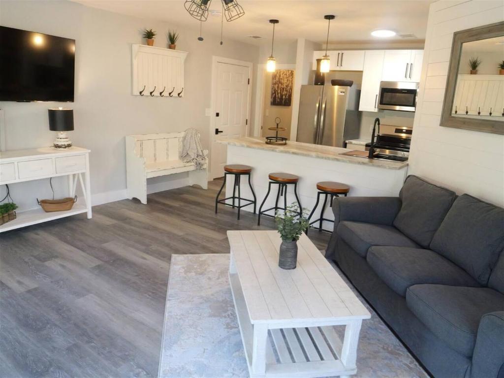a living room with a couch and a kitchen at Rivers Edge 703c in Helen