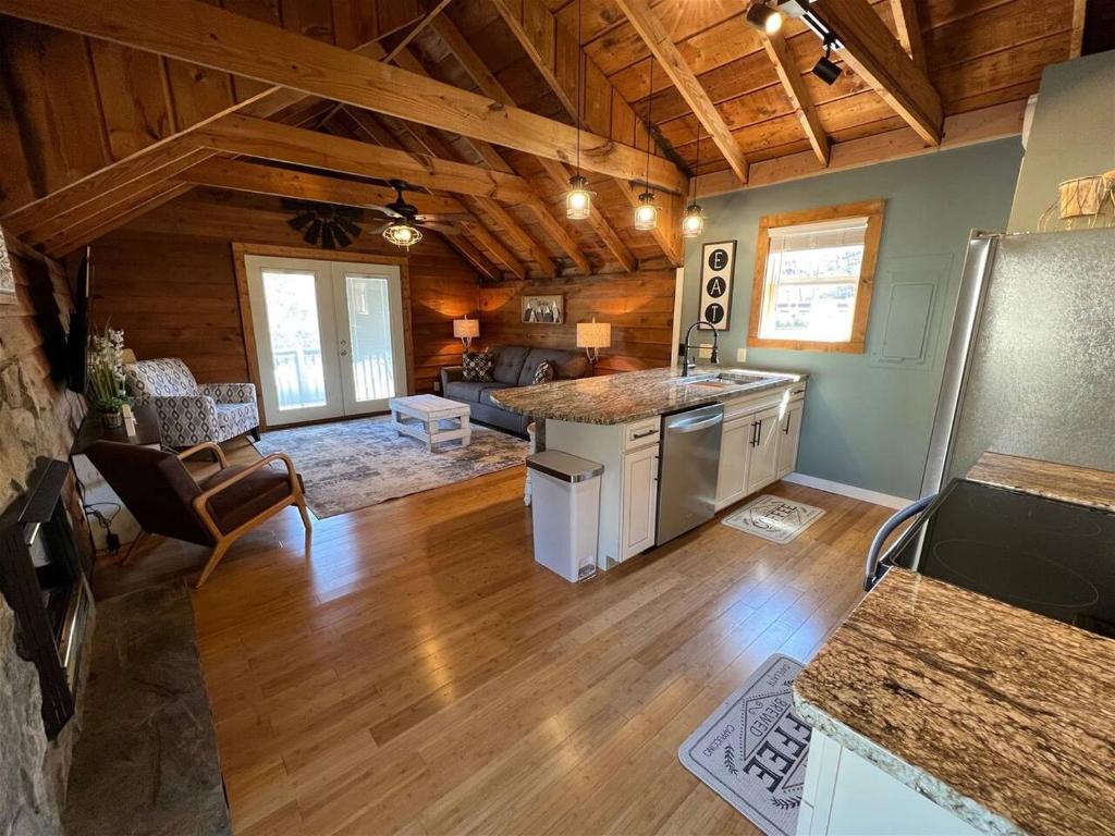 a large kitchen and living room in a log cabin at Bavarian Brook Condo 14 in Helen