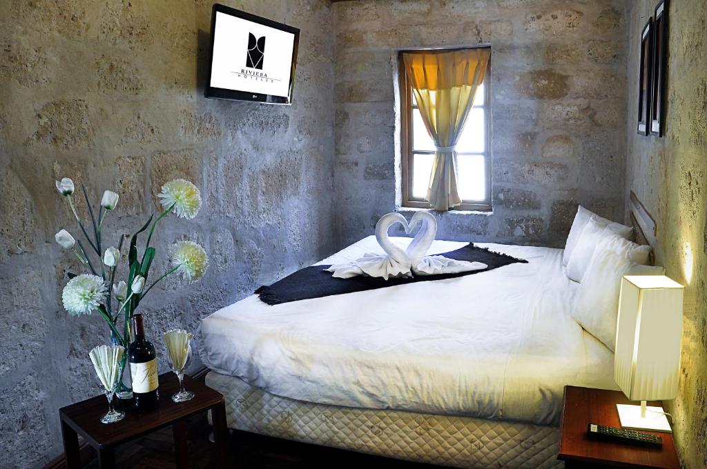 a bedroom with a bed with a swan on it at Hoteles Riviera Colonial in Arequipa