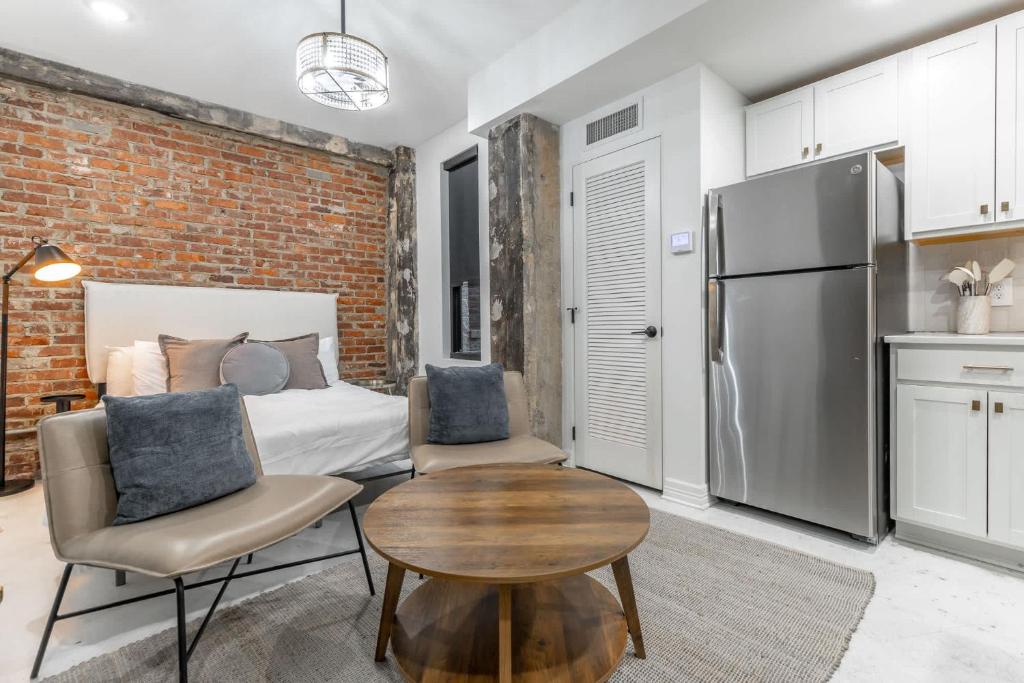 a bedroom with a bed and a table and a refrigerator at Park Hotel Studio Suite 303 in Chattanooga