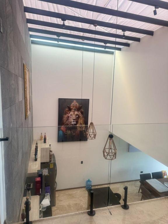a room with a painting of a lion on the wall at Residencia con alberca in Las Ánimas