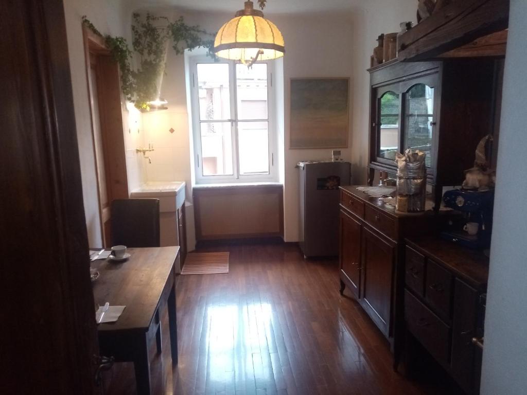a large kitchen with a table and a window at Affitta camere Explora caffè in Trieste