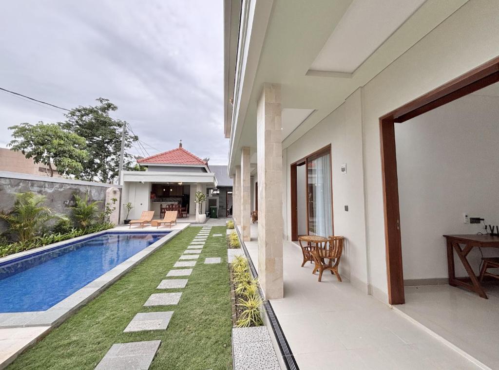 an external view of a villa with a swimming pool at Paramulia house in Canggu