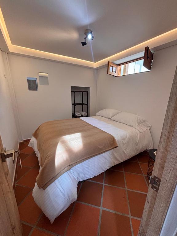 a bedroom with a large bed in a room at Hostal Boutique Loto de Belén in Bogotá
