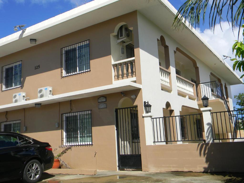 a building with a car parked in front of it at Pedro Villas in Tamuning