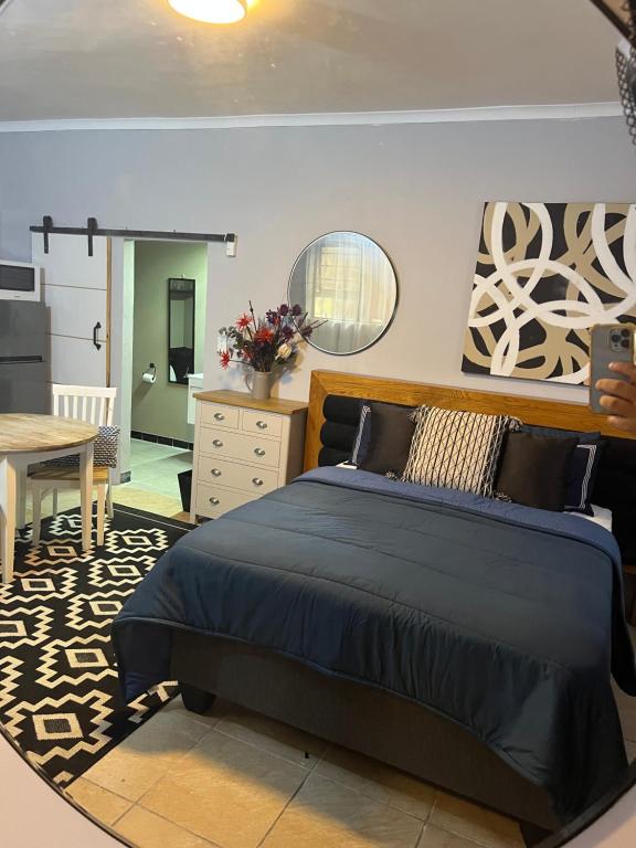 a bedroom with a large bed and a table at Little West in Margate