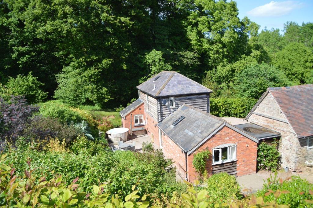 an aerial view of a house with trees in the background at Stable Cottage at Hanley Mill in Tenbury
