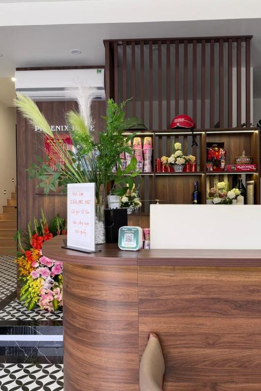 a person sitting at the counter of a flower shop at Phoenix home in Phù Ninh
