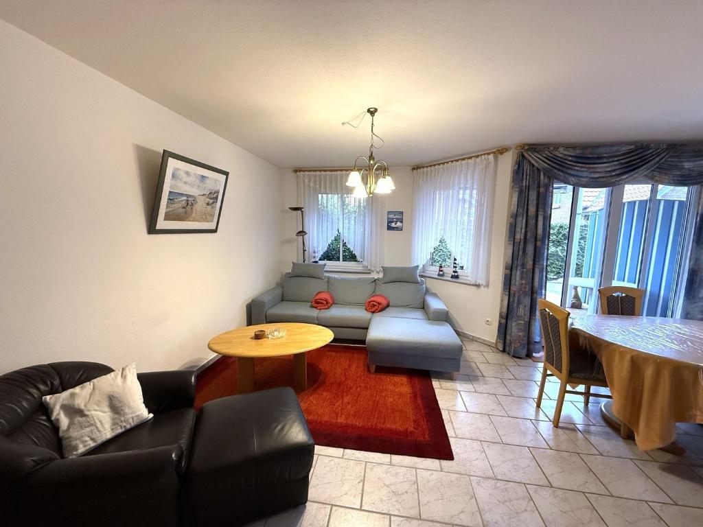 a living room with a couch and a table at Haus Meeresrauschen, Whg 1 in Duhnen