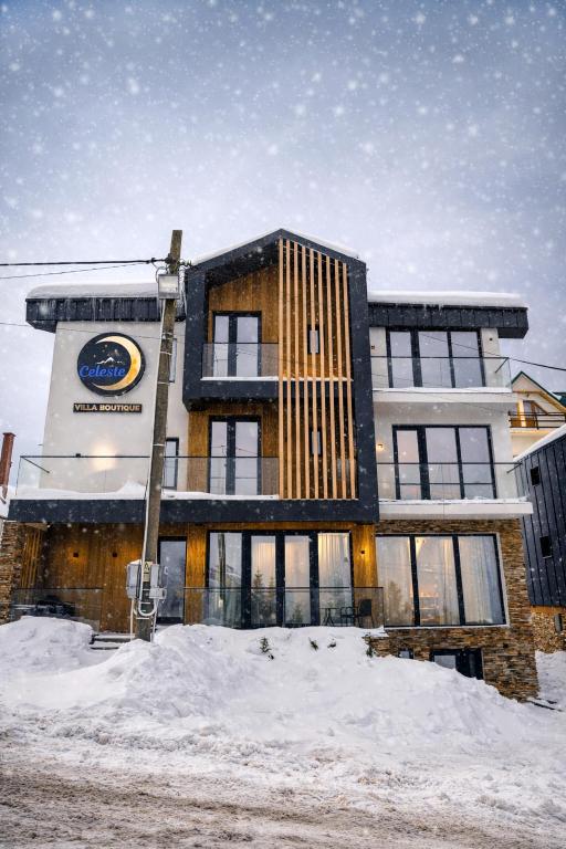 a building with snow in front of it at Celeste Villa Boutique in Ranca