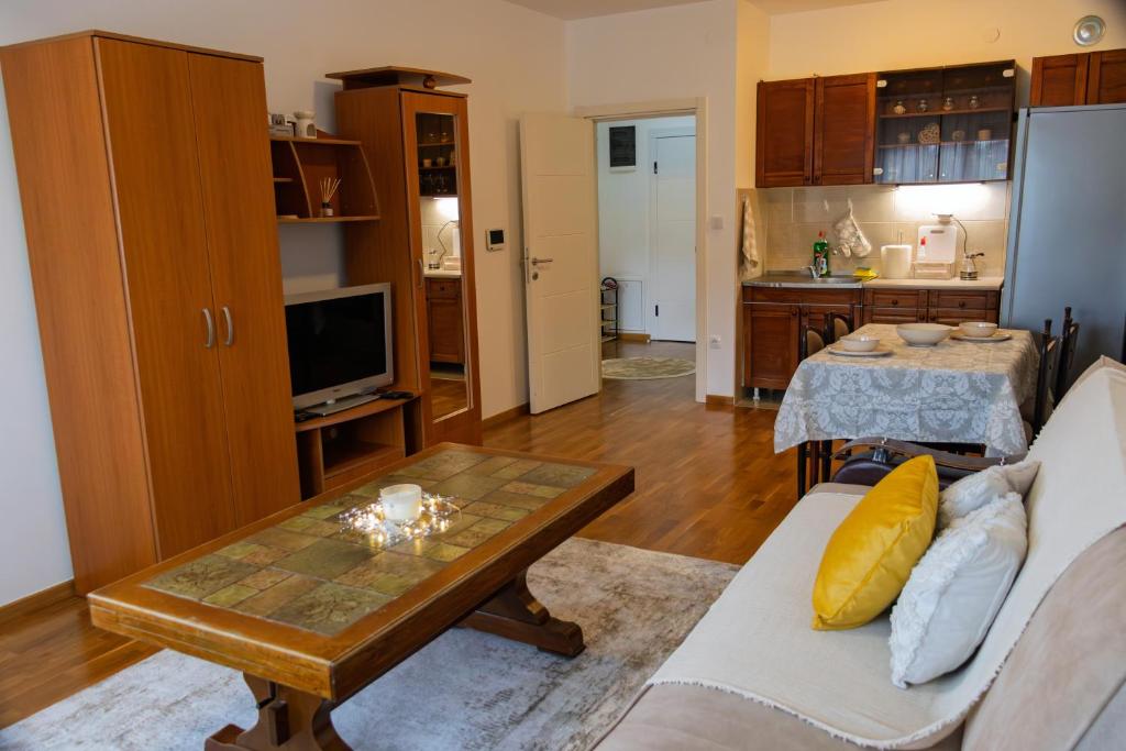 a living room with a couch and a table at D&A Apartments in Novi Pazar