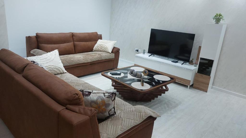 a living room with a couch and a television at Onix 1 in Soko Banja