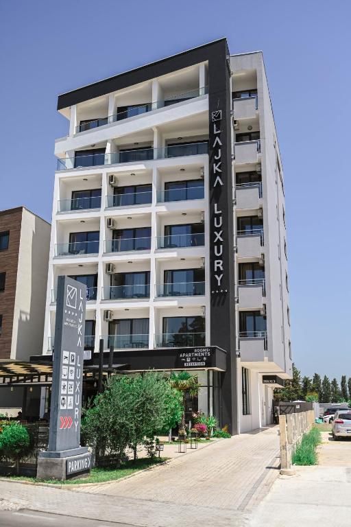 a large building with a sign in front of it at Hotel Lajka Luxury in Ulcinj