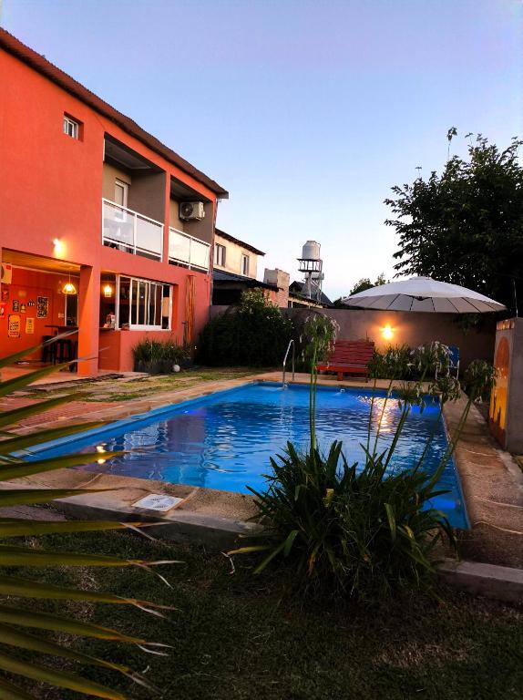 a swimming pool in a yard next to a building at Los Aromos in Federación