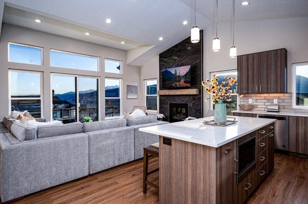 a kitchen and living room with a couch and a fireplace at Powder Mtn Chalet B4 Ski Escape Hot Tub & View in Eden