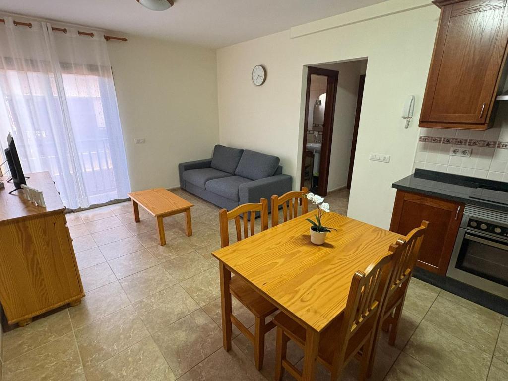 a kitchen and dining room with a table and a couch at Valthi in La Restinga