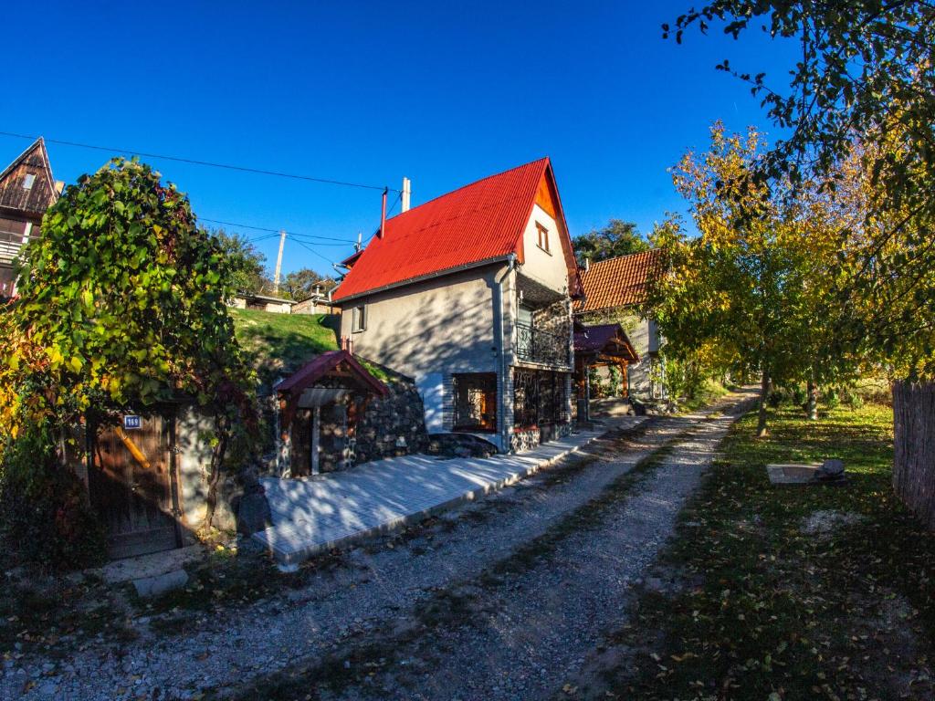 an old stone house with a red roof at Chata Geruša in Čebovce