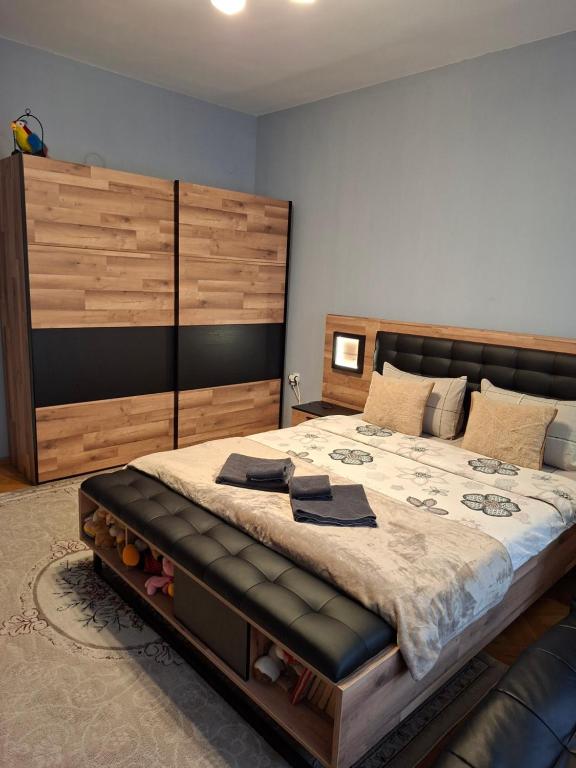 a bedroom with a large bed with a large headboard at Apartament Sofia in Sofia