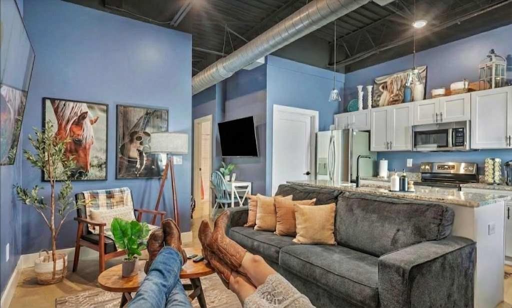 a person laying on a couch in a living room at New Studio- 2 beds 7 mins to DT in Nashville