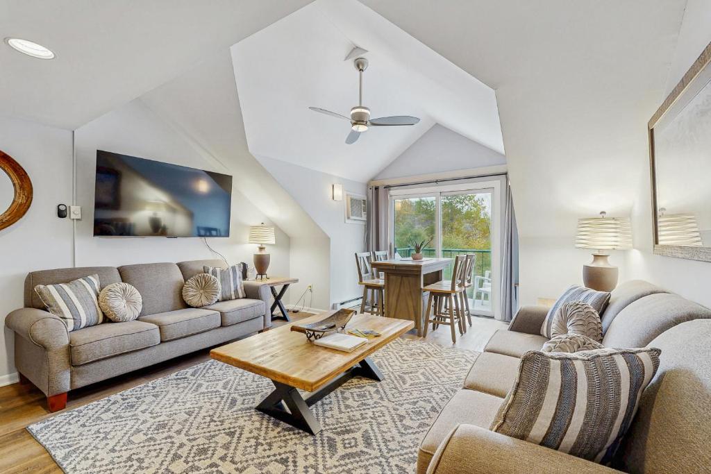 a living room with a couch and a table at Loon Landing at Rivergreen in Lincoln