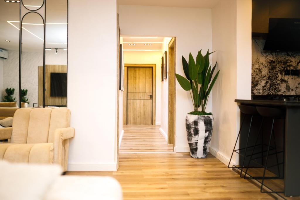 a hallway with a vase with a plant in it at Avenue 28th Apartment in Benin City