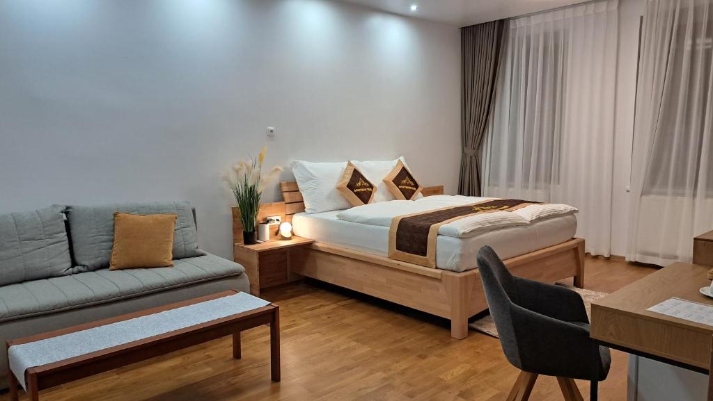 a hotel room with a bed and a couch at Apartmány Farní in Moravská Třebová