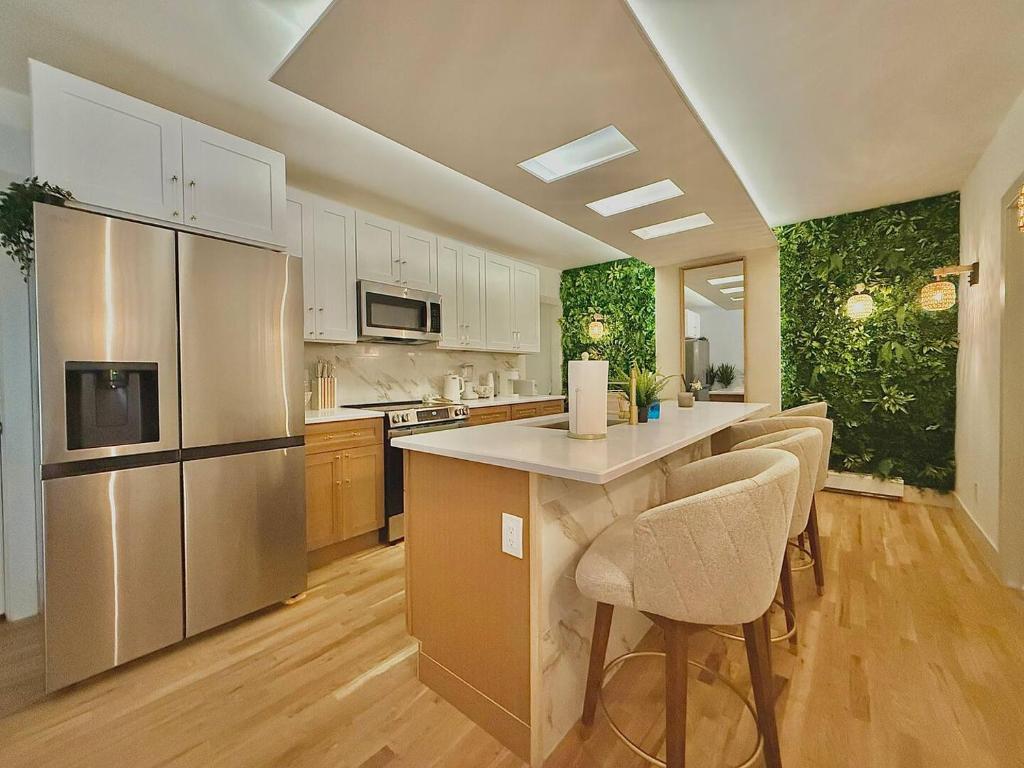 a kitchen with stainless steel appliances and wooden floors at Spring Rooms by Yale & Downtown in New Haven