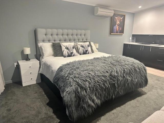 a bedroom with a large bed with a furry blanket at Thornton Hideaway Private Standalone Retreat, Walk to Cambridge Town Centre in Cambridge