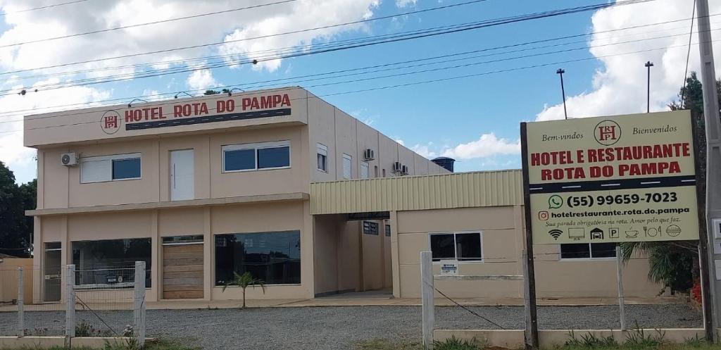 a building with a no parking sign in front of it at Hotel e Restaurante Rota do Pampa in Estância Teixeira