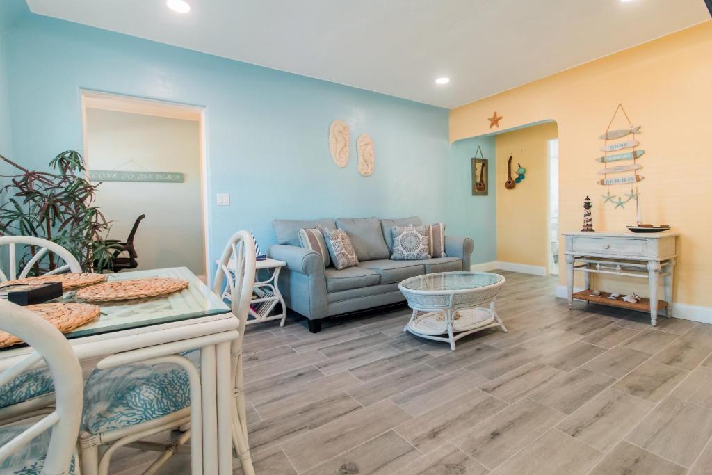 a living room with a couch and a table at Gorgeous Beach Condo in St. Petersburg